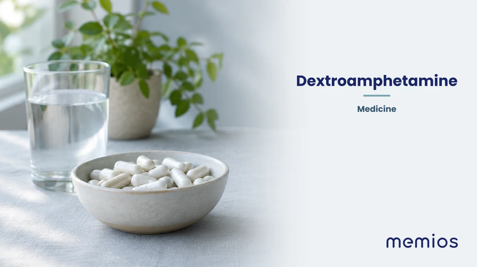 Photograph for Dextroamphetamine: plain unmarked tablets in a dish beside a glass of water on pale linen.
