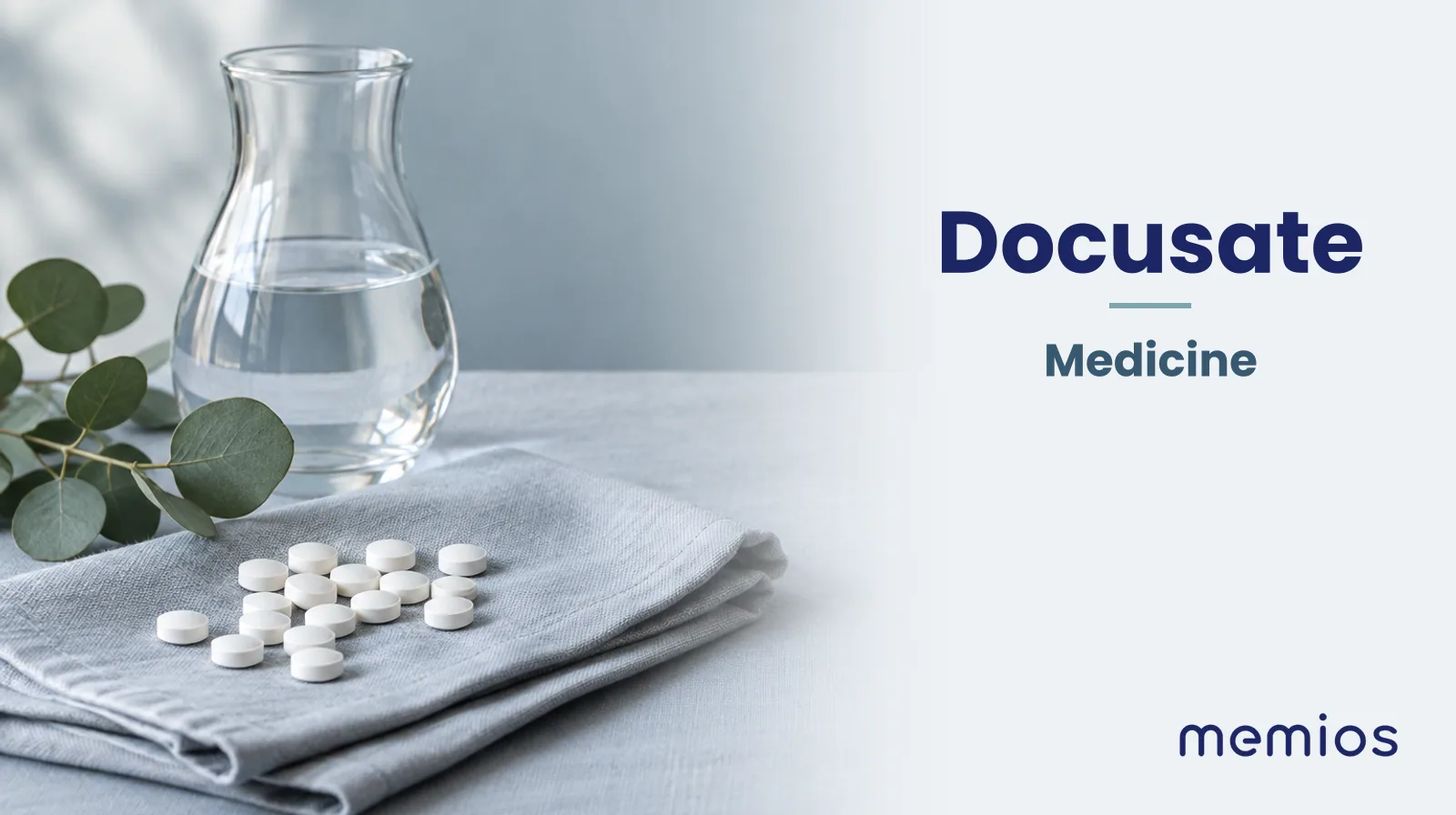 Photograph for Docusate: plain unmarked tablets in a dish beside a glass of water on pale linen.