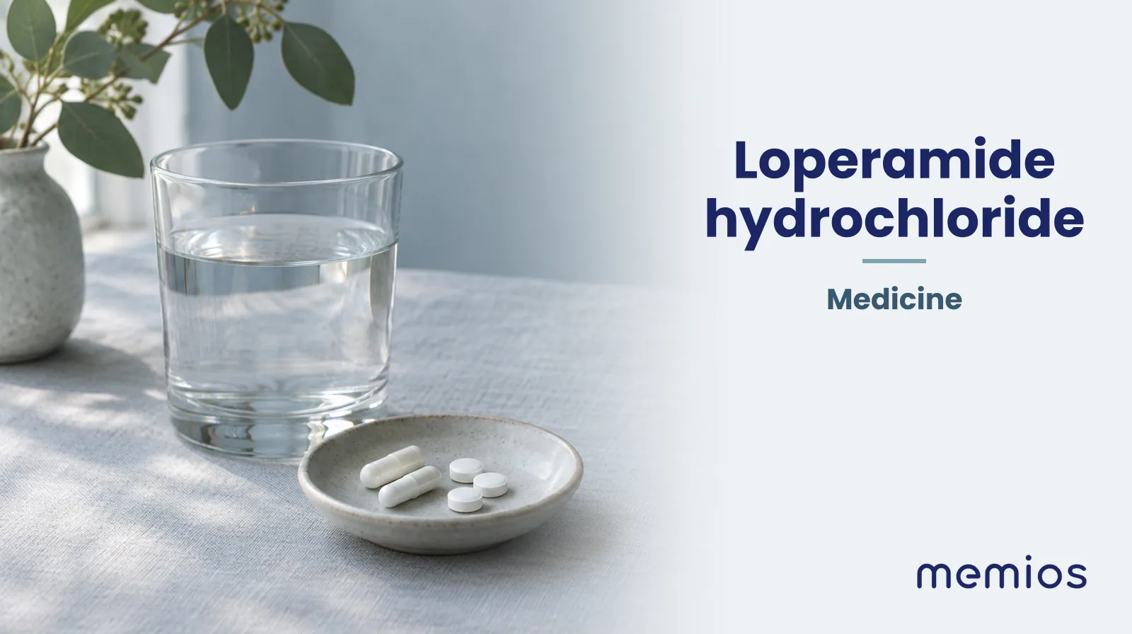 Photograph for Loperamide hydrochloride: plain unmarked tablets in a dish beside a glass of water on pale linen.