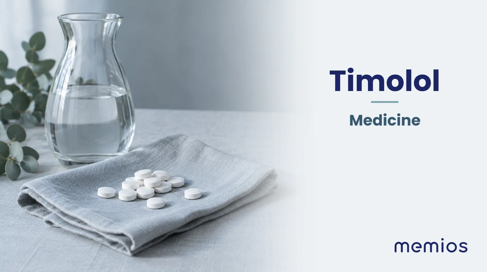 Photograph for Timolol: plain unmarked tablets in a dish beside a glass of water on pale linen.