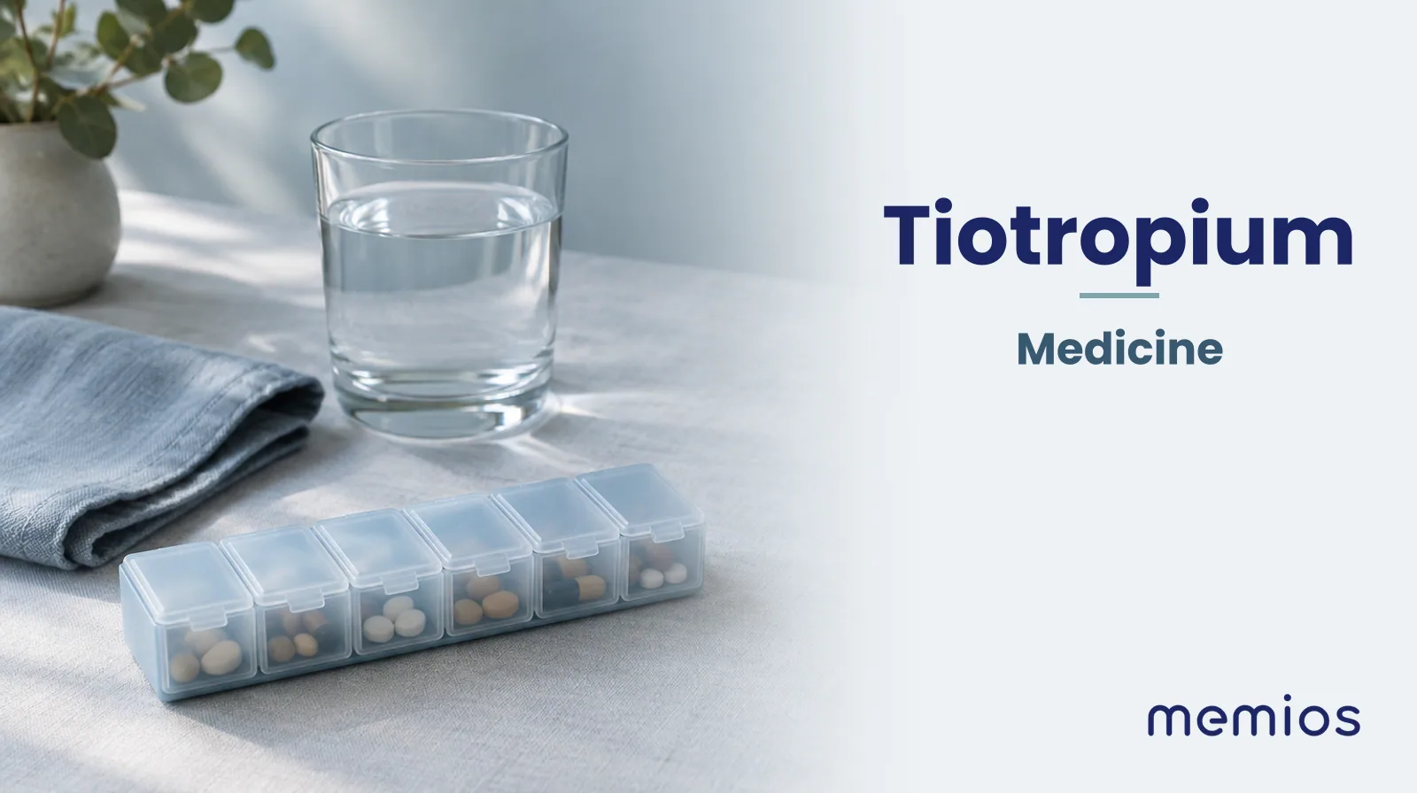 Photograph for Tiotropium: plain unmarked tablets in a dish beside a glass of water on pale linen.